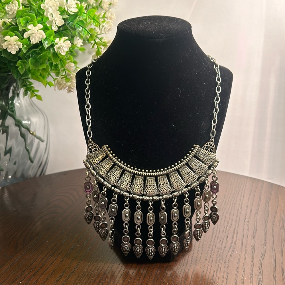 Intricate silver tone statement necklace with lobster closure